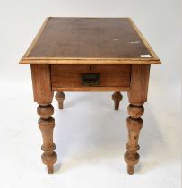 An early 20th century pine table with inset canvas top, raised on substantial turned supports with