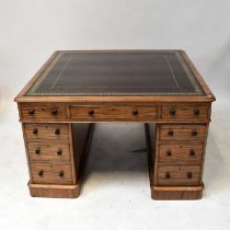 An early 20th century mahogany partners' desk of small proportions, with gilt tooled oxblood leather