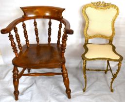 Two modern reproduction chairs, one in Louis XIV style gilt metal, and a captain's chair, possibly