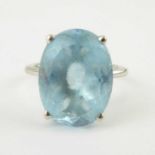 A 9ct white stone dress ring with claw set oval blue cut stone, size O, approx. 6g.