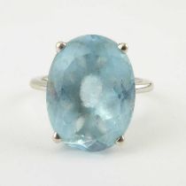 A 9ct white stone dress ring with claw set oval blue cut stone, size O, approx. 6g.