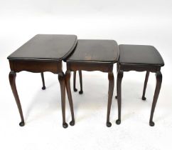 A contemporary mahogany nest of three tables, raised on slender Queen Anne supports to pad feet.