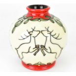 MOORCROFT; a small tube lined bulbous vase decorated with leaping deer and mistletoe, with red glaze