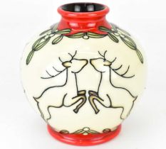 MOORCROFT; a small tube lined bulbous vase decorated with leaping deer and mistletoe, with red glaze