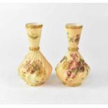 ROYAL WORCESTER; a pair of gilt-heightened blush ivory vases, Shape 1452, with puce backstamps