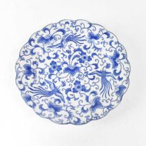 A 20th century Chinese blue and white plate with scalloped edge, decorated with phoenixes flying