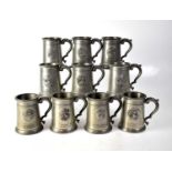 A collection of ten commemorative glass bottom pewter mugs, with depictions of great Naval and