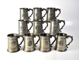 A collection of ten commemorative glass bottom pewter mugs, with depictions of great Naval and