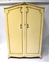 A five-piece gilt-heightened cream bedroom suite comprising two double wardrobes, a chest of five