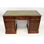 A reproduction mahogany nine-drawer twin pedestal desk, with gilt tooled green leather inset top,