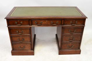 A reproduction mahogany nine-drawer twin pedestal desk, with gilt tooled green leather inset top,