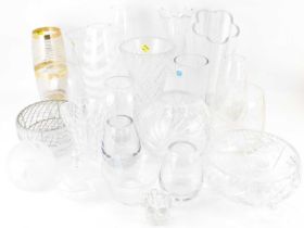 A large collection of clear, cut, pressed and art glass vases, bowls and dishes, to include