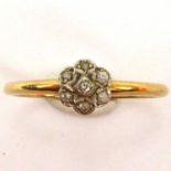 An 18ct gold ring with small diamond floral cluster, size P, approx. 2g.