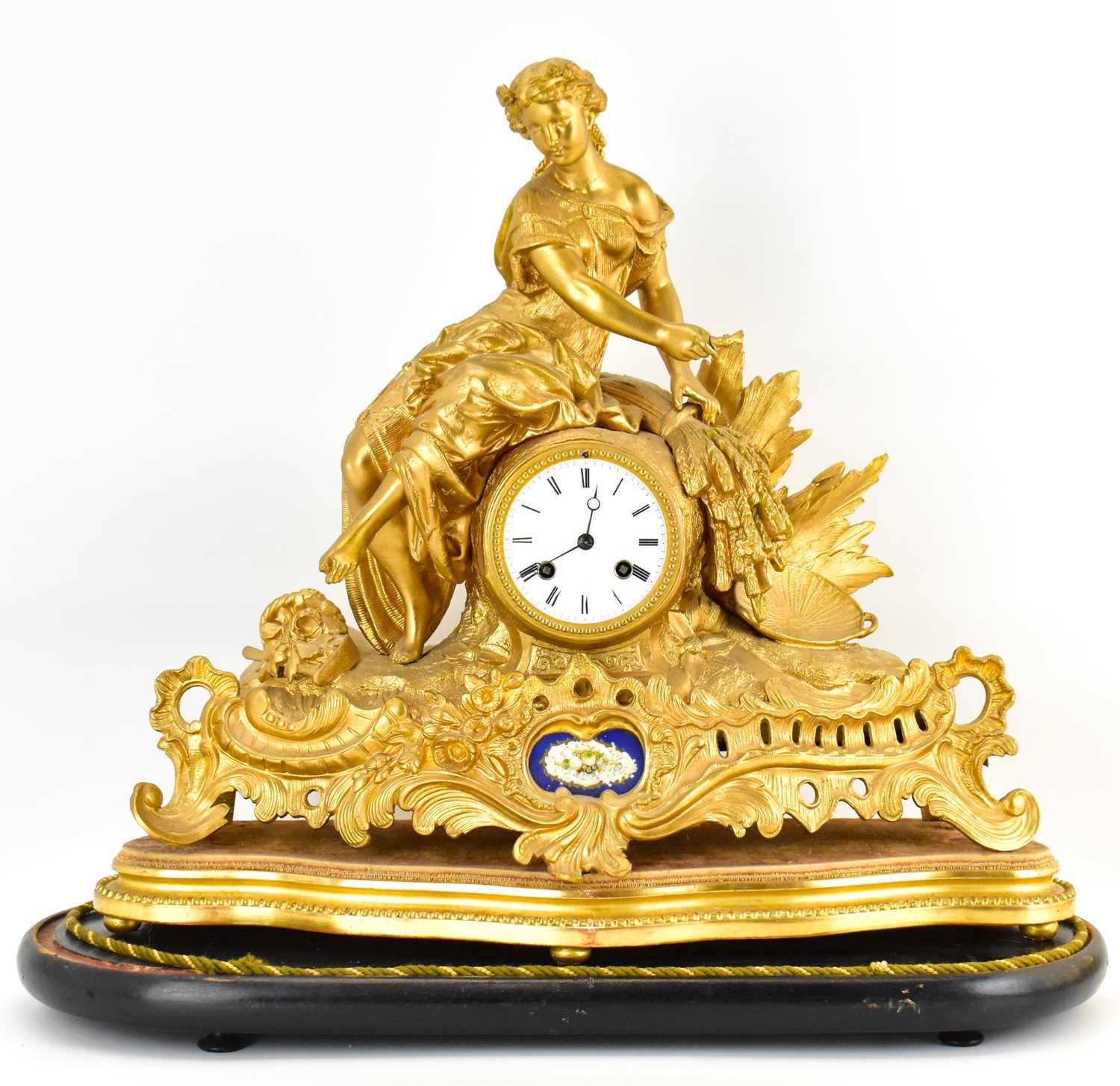 A 19th century gilt metal mantel clock, the white enamelled dial set with Roman numerals and two key