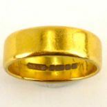 A 22ct gold wedding band, size L/M, approx. 5.4g.