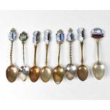 Eight commemorative souvenir spoons for various shipping lines, seven with enamelled pictorial