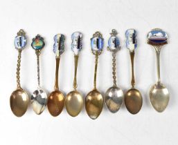 Eight commemorative souvenir spoons for various shipping lines, seven with enamelled pictorial