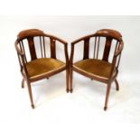 A pair of Edwardian mahogany inlaid bow back chairs, with upholstered seat pads, raised on square