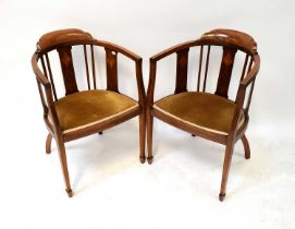 A pair of Edwardian mahogany inlaid bow back chairs, with upholstered seat pads, raised on square