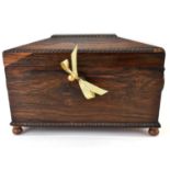 A 19th century Victorian rosewood sarcophagus-form tea caddy with two internal lidded compartments