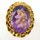 A vintage 9ct gold amethyst dress ring, the oval cut amethyst in claw set mount with open work head,