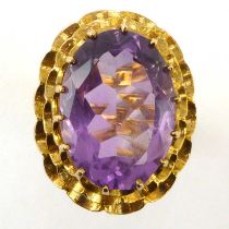 A vintage 9ct gold amethyst dress ring, the oval cut amethyst in claw set mount with open work head,