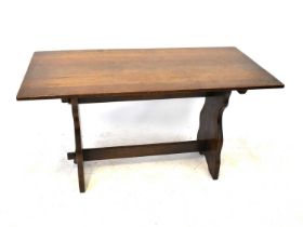 A mid-20th century oak refectory-style dining table with slab ends and cross stretcher, 74 x 137 x