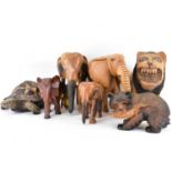 Six carved wood animals, comprising four elephants, a bear with salmon in mouth and a naive-