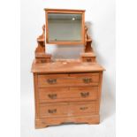 A 20th century pine dressing chest with bevelled mirror plate above two short jewellery drawers