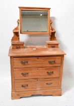 A 20th century pine dressing chest with bevelled mirror plate above two short jewellery drawers