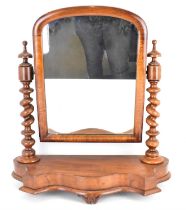 A 19th century mahogany swivel toilet mirror with domed top, on barleytwist and turned finial