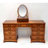 A reproduction yew wood crossbanded and line inlaid nine-drawer kneehole dressing table, 77 x 155