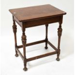 An early 20th century oak occasional table raised on carved and turned block stretchered supports,