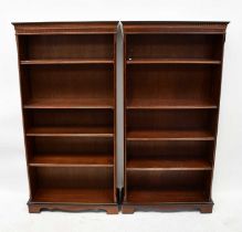 A pair of reproduction mahogany crossbanded and line inlaid open bookcases, the dentil moulded