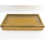 A tabletop jewellery display case of tapered form, 11 x 61 x 32cm, with hook and ring fastener to