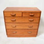 A modern solid oak chest of two over three long drawers.