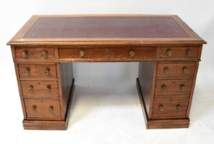 An Edwardian mahogany nine-drawer twin pedestal desk, with tooled oxblood leather inset panel