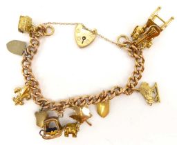 A 9ct gold charm bracelet with nine gold charms to include oxen and sled, chair and guitar, shields,