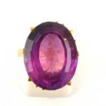 A Continental gold dress ring with an oval cut claw set amethyst stone, size P, approx. 8.5g.