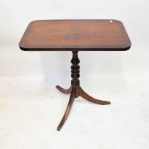 A walnut crossbanded rounded rectangular tilt-top occasional table, raised on turned column to three