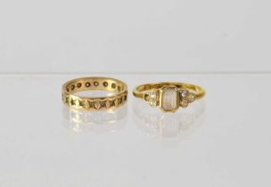 Two 9ct gold rings, comprising a band ring set with white stones (one stone missing), stamped '375',