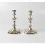 K. M. SILVER; a pair of Elizabeth II hallmarked silver candlesticks with knopped stems, and