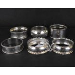 Seven various hallmarked silver napkin rings, to include a pair with frilled edge and initialled '