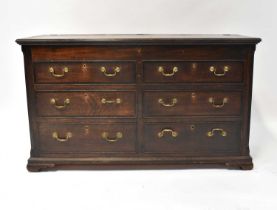 A 19th century and later oak mule chest with hinged moulded cross-banded top above a pair of faux