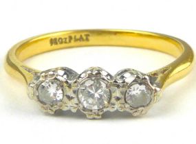 An 18ct gold three-stone diamond ring, the diamonds set in platinum open mounts, size Q, approx. 2.