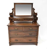 A stained oak dressing chest with bevelled mirror plate above a pair of jewellery drawers and open