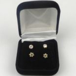 Two pairs of 9ct gold stud earrings, comprising a set of tiny flower head diamond cluster and a pair