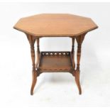 An early 20th century oak octagonal occasional table, raised on turned supports united by a