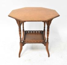 An early 20th century oak octagonal occasional table, raised on turned supports united by a