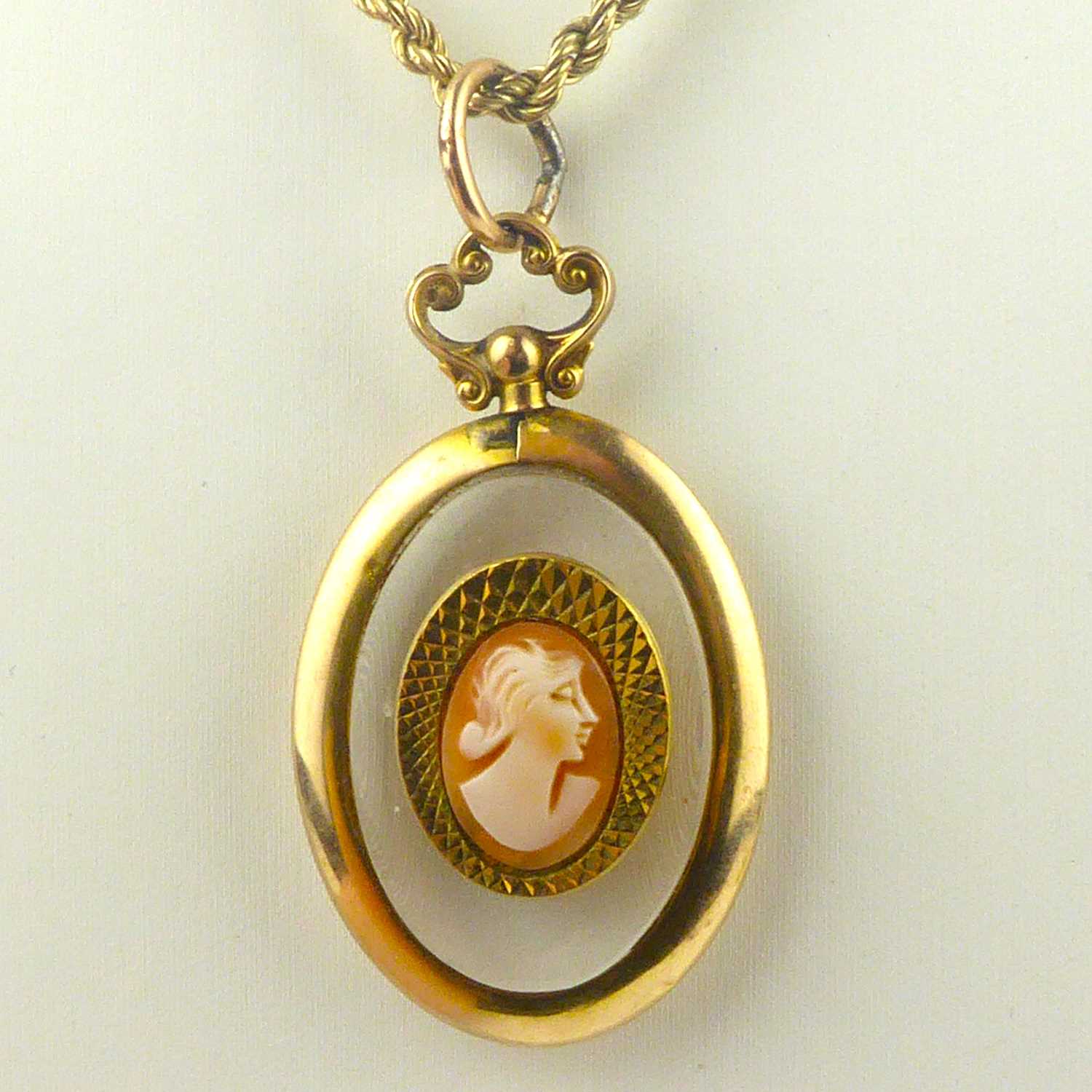 A clear oval necklace pendant in a 9ct gold mount, with a later applied cameo and gold-coloured - Image 2 of 4